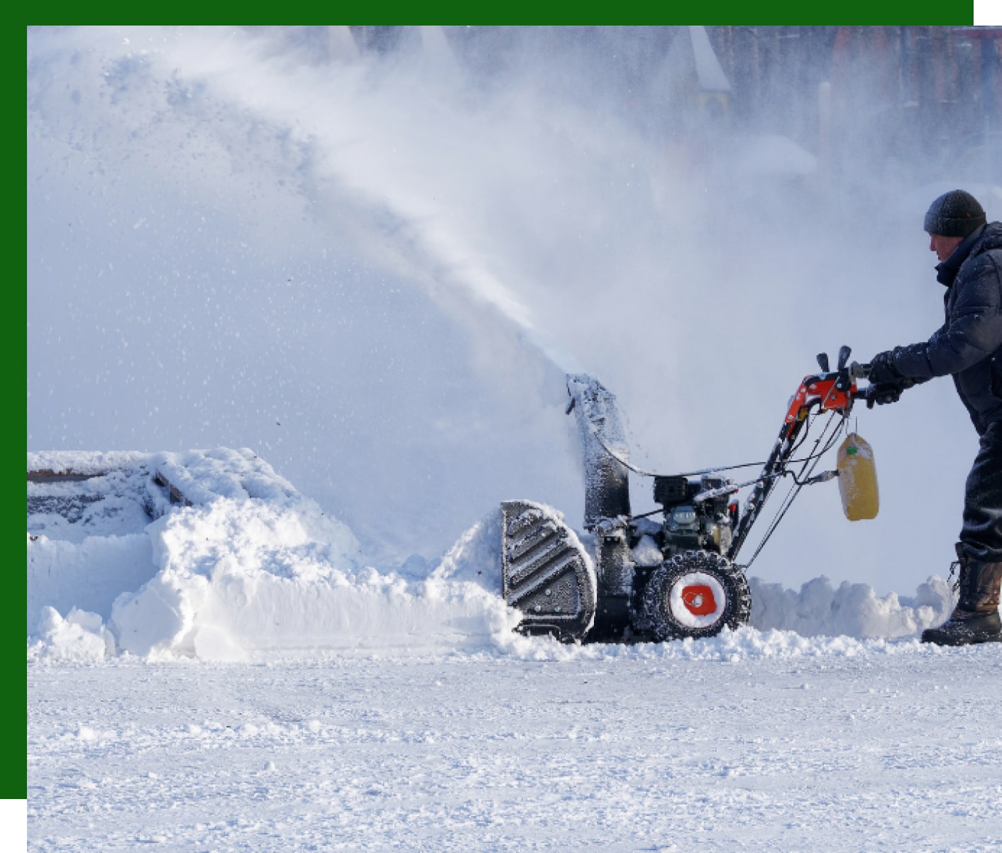 a guy plowing snow using a machine